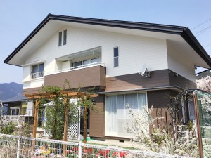 塗装工事はまず最初にバイオ高圧洗浄で外壁の汚れを徹底的に落とします。殺菌消毒作用のある洗浄剤を使用しカビやコケなどの汚れを根っこから駆除しました。洗浄を徹底的に行うことにより壁面と塗装の密着性が良くなり、塗料の性能が格段に長持ちするようになります。

外壁はペットの犬がかじって剥がれてしまっていた部分がありましたが補修方法を見極め、パテでしっかりと補修しました。必要な補修を施した後、下塗り上塗り、防水コーキングで丁寧に仕上げています。

スレート屋根は劣化が進み、上から塗装をしても長く持たせることができない状態でした。そのためカバー工法で屋根リフォームを行いました。カバー工法は、既存の屋根の上に、防水シートと新しい屋根材をかぶせる工法です。雪止めなども取り付け、長く安心して住んでいただける外装リフォームが完成しました。